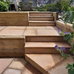 Sandstone paving steps timber retainer